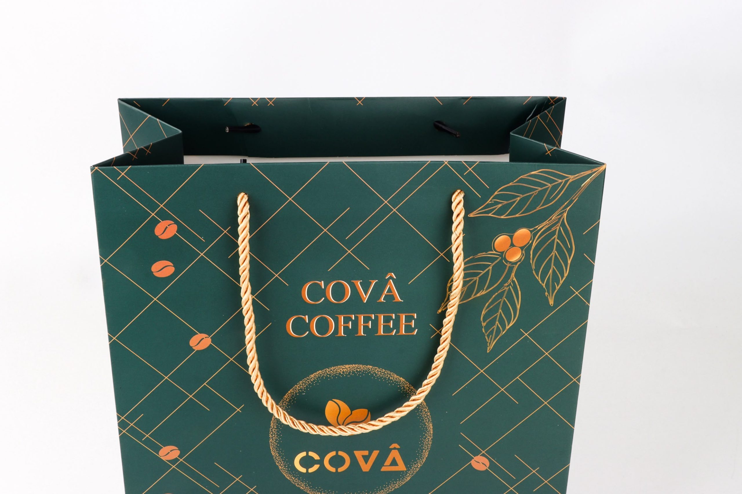 Close up of the Covâ Coffee bag showing the gold rope handles and logo